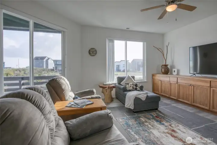 Large living room windows are angled to catch the waves splashing up from the Jetty.