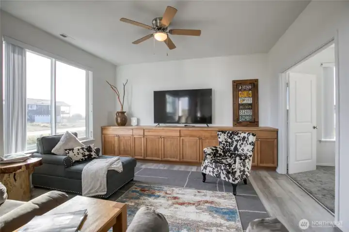 Built in cabinets for storage, and one of three bedrooms off to the right.