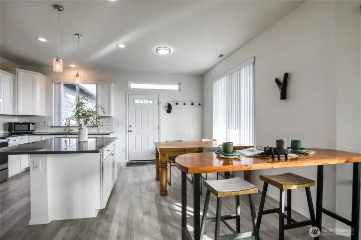 Looking back towards the front door, you can see more dining space and a beautiful kitchen!