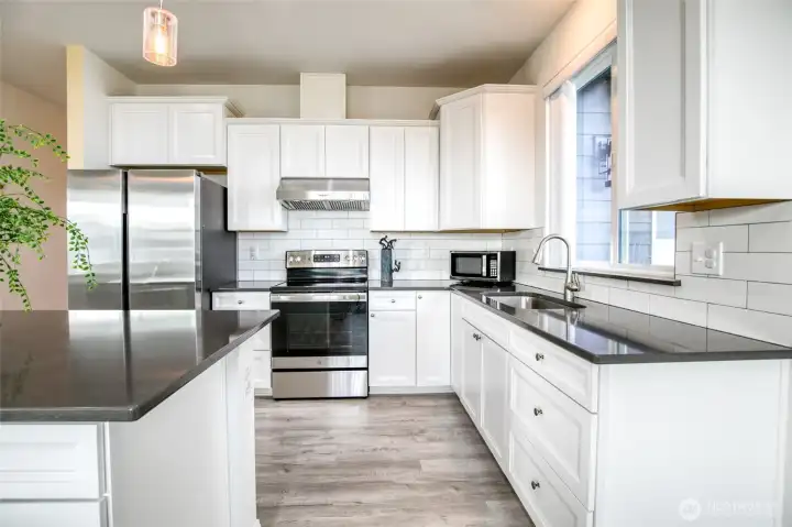 Classic tile backsplash adds to the beauty.  And not to worry!  If you want a dishwasher, the plumbing is next to the sink and it would be easy to remove the end storage to install the appliance.
