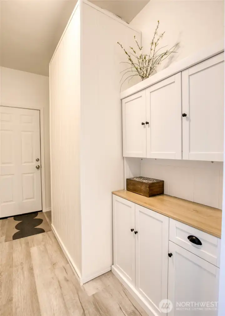 The other side of the laundry room has additional storage cabinets.