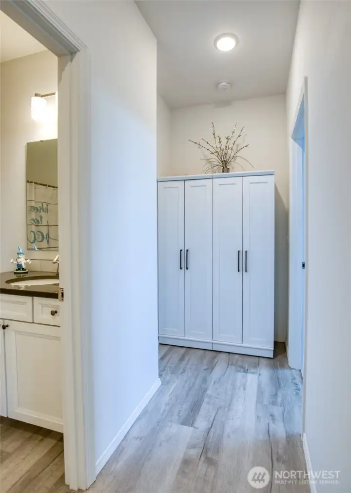 This hallway turns towards the main bath, and access to the primary suite.
