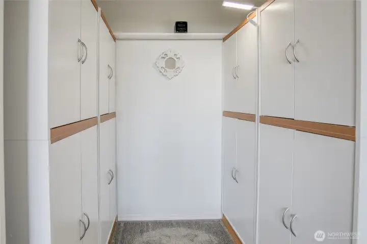 Walk in closet in the primary bedroom is nice and tidy with this closet system!