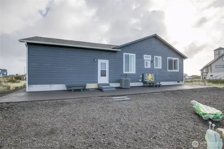 That asphalt path around the entire house is so nice!  And low maintenance landscaping all the way around!