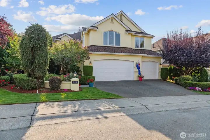 Elegant street presence with manicured landscaping in a quiet Sammamish neighborhood, showcasing timeless curb appeal and a welcoming entry.