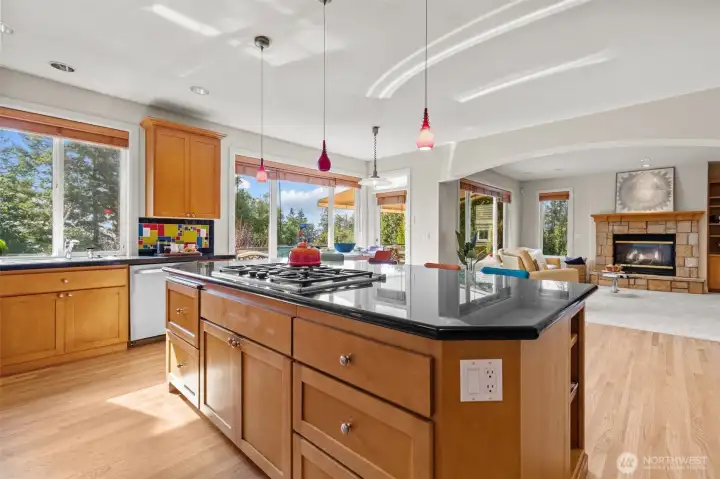 Open-concept kitchen showcasing generous counter space, pendant lighting, and sightlines to the main living areas.