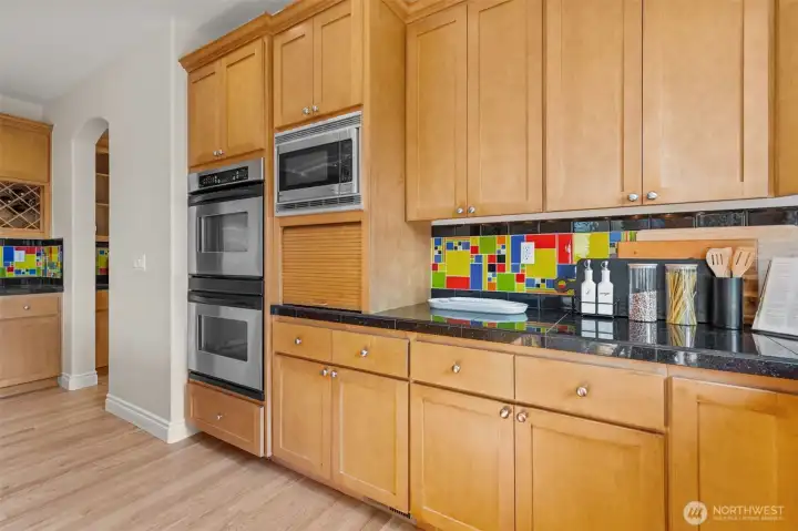Abundant cabinetry and built-in appliances provide both style and storage in this thoughtfully designed kitchen.