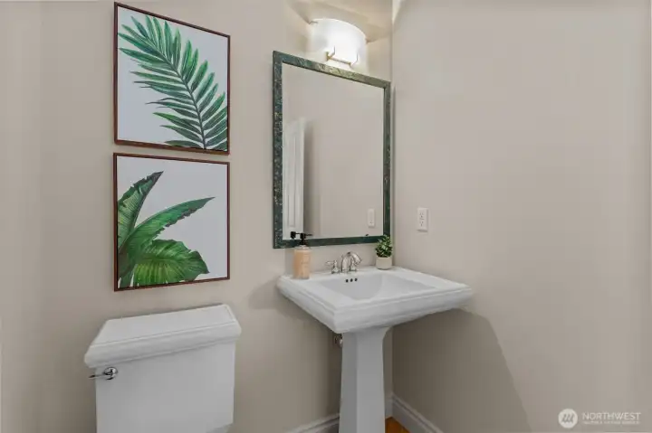 Stylish powder room with pedestal sink and tasteful finishes, ideal for guests.