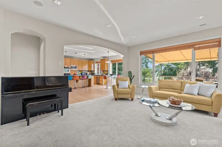 Open family room perspective highlighting seamless flow to the kitchen and outdoor living areas.