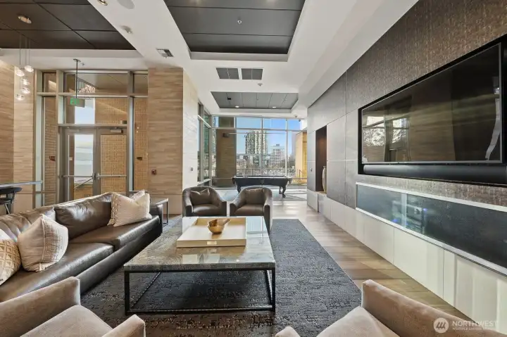 A newly renovated clubhouse perfect for entertaining, equipped with a chef's kitchen, pool table, and large dining table.