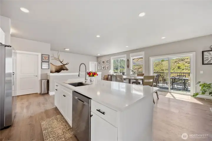 Views of open kitchen with large island plus great room