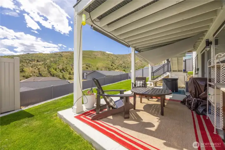 View of covered deck and lawn
