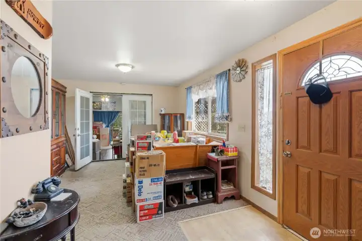 Entry and Dining with French Doors leading to Family Room.