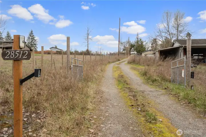 Gated Entry with Gravel Driveway leads into this fantastic property.
