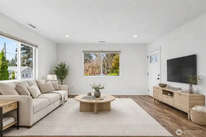 View of the living room from the kitchen. Virtually staged.