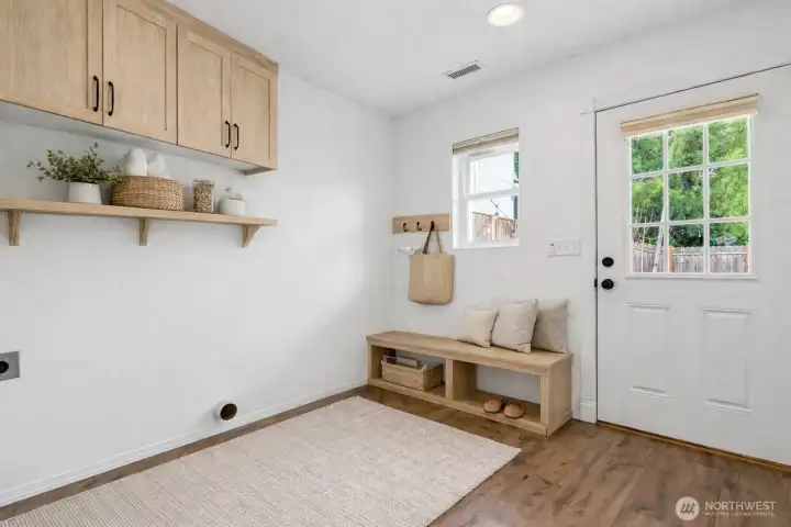 Virtually staged laundry/mudroom.