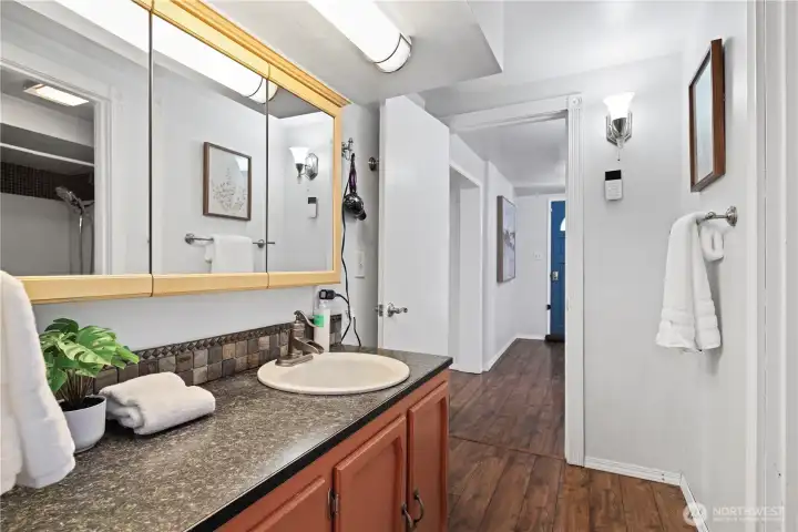 Primary bath features dual vanity and full bath