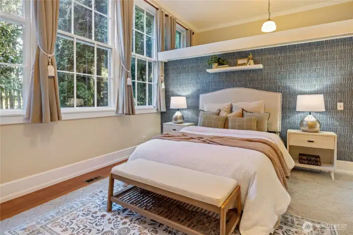 Walk in closet behind bed wall.