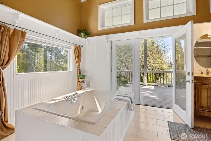 Primary bath is a dream with jetted tub and access to porch.