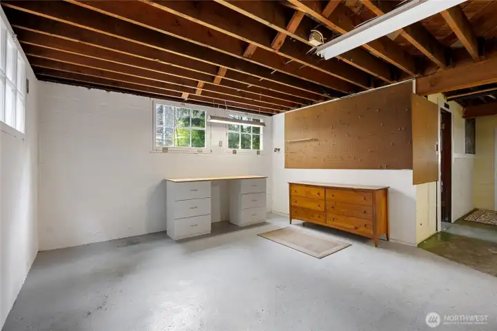 Room to the right, original boys bathroom has plumbing and second water heater.