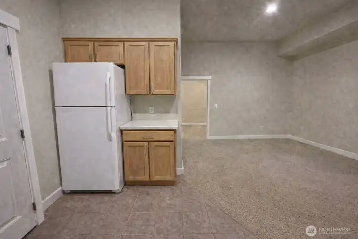 AI staging of proposed kitchen in ground bonus room.