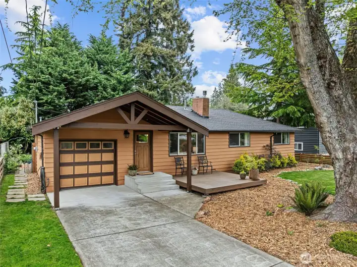 One car garage complimented by a NW portico provides a half carport space. Driveway plus off-street parking.