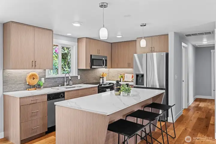 Stunning open kitchen offers high end finishes and a center island that adds seating for your gatherings.