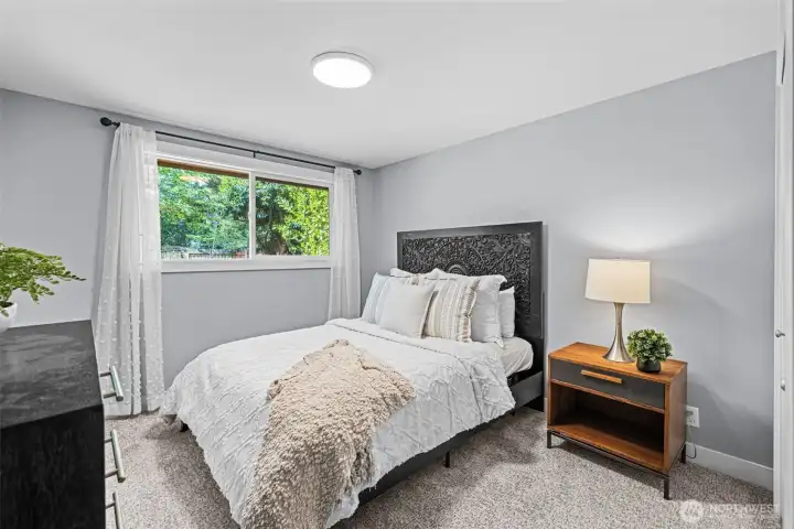 Primary suite with room for a king or queen. Bed in photo is a queen.