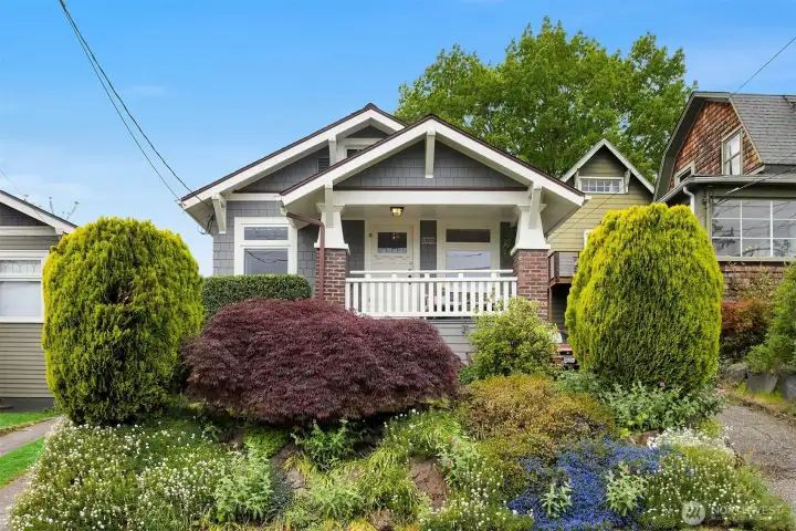 Quintessentially craftsman. With leaded glass windows and the perfect rocking chair front porch.