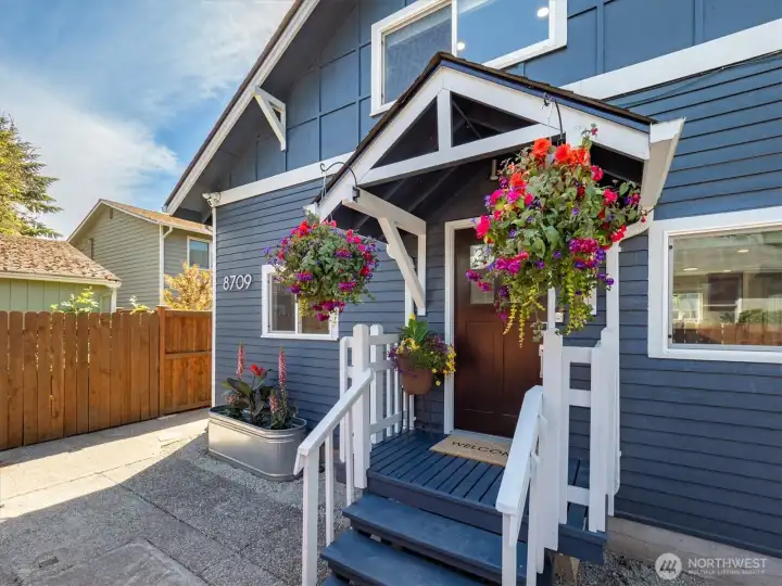 Great porch and entry into the home popping with color right now.
