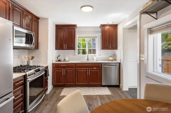 Love the sink overlooking the backyard. Easy to make sure you are not missing out on exterior activities. Side deck door is just to your right.