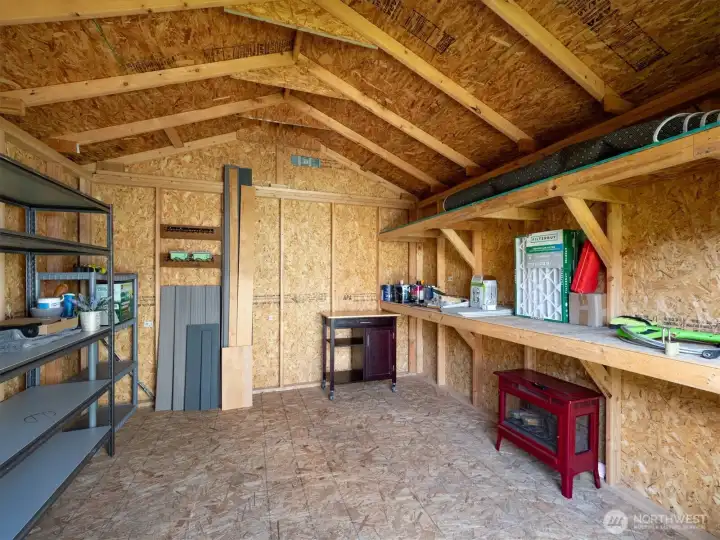 This shed tucked in the corner offers plenty of space for storing garden equipment or other belongings.