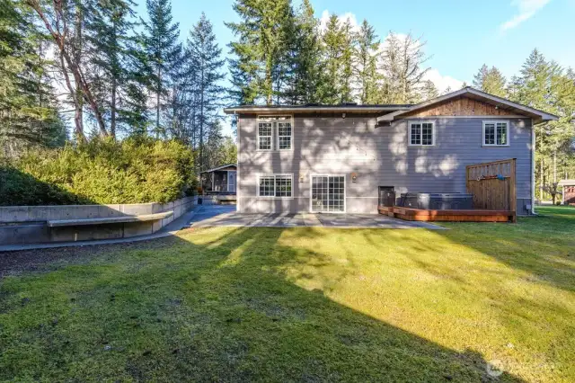 Side of home w/ hot tub and deck
