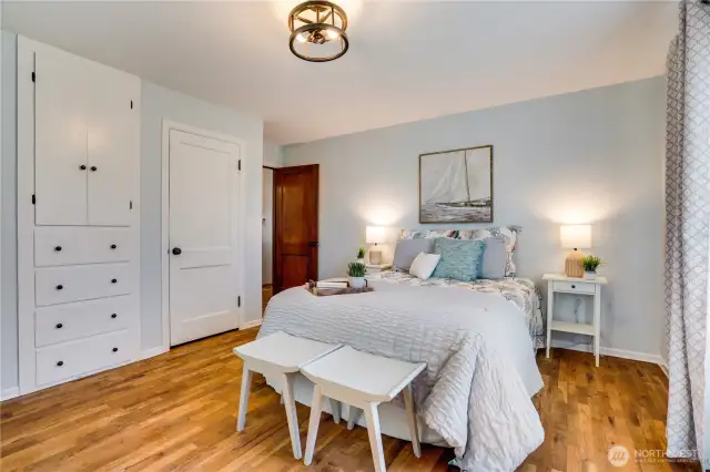 The front main floor bedroom includes a closet and built-ins for storage.