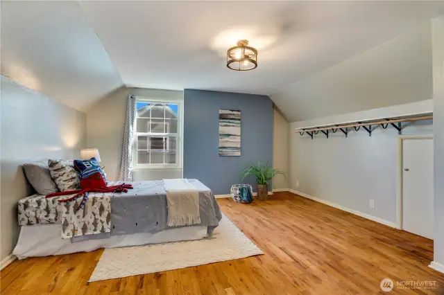 Take a right at the top of the stairs into this 4th bedroom on the east side of the house. Wood floors, built-ins, and a small closet finish this room.