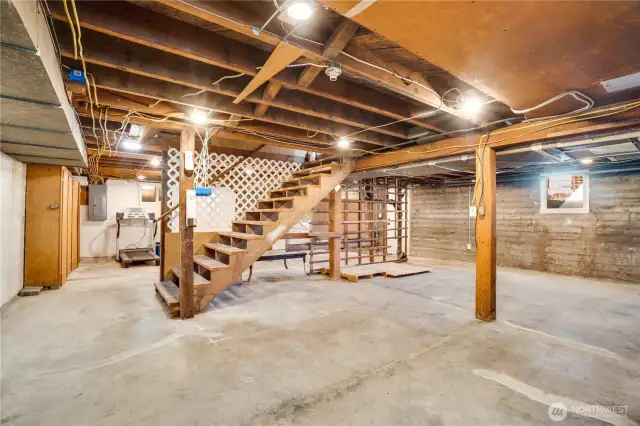 Take the stairs down from the main floor hallway to the 952 sq ft basement. Wooden storage lockers stand agains the wall, and there's plenty of room for additional shelving and a work bench.