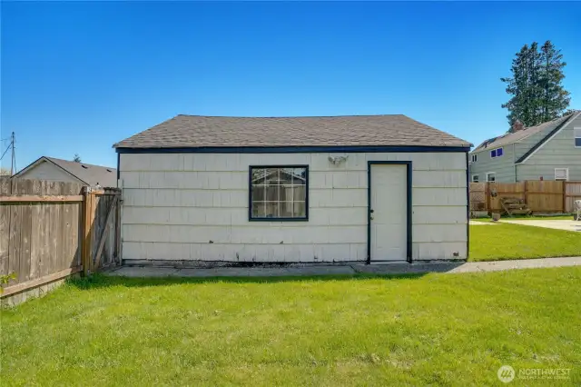 A side door in the garage opens to the fully fenced back yard with a gate to the alley.