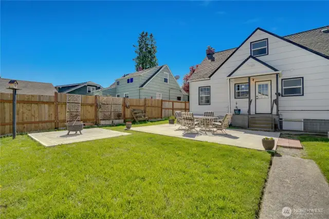 Even with the patios and hot tub pad, there's plenty of lawn space and room for more garden beds or trees. The sellers enjoyed projecting movies onto the back of the garage in summer.