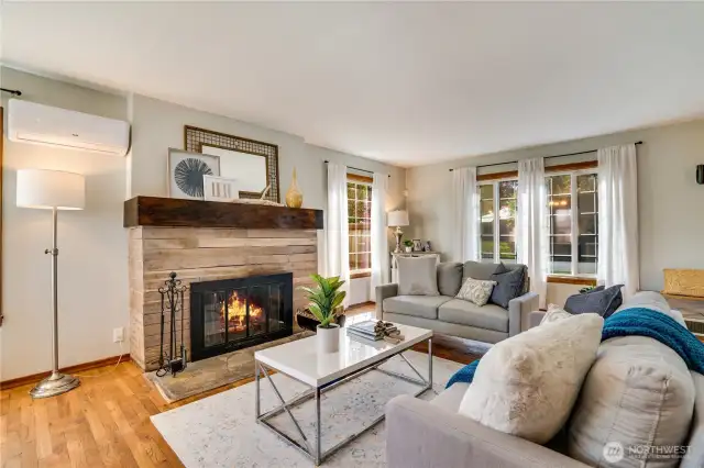The house is heated by a gas furnace along with ductless mini-split units for heating and cooling. The wood-burning fireplace with its sturdy mantel is a cozy focal point for the room.