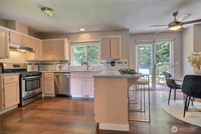 Light-filled kitchen with a convenient breakfast bar, stainless steel appliances and gas cooktop – perfect for casual meals or chatting with guests while you cook.