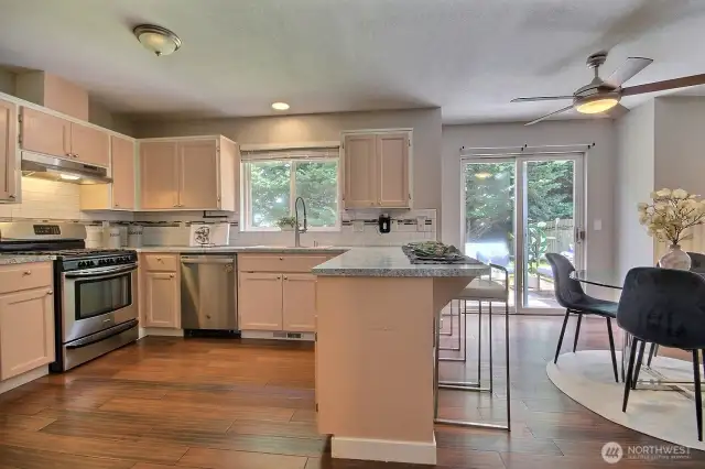 Light-filled kitchen with a convenient breakfast bar, stainless steel appliances and gas cooktop – perfect for casual meals or chatting with guests while you cook.