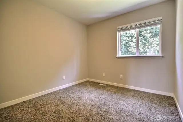 Guest bedroom #1 overlooks the back yard.