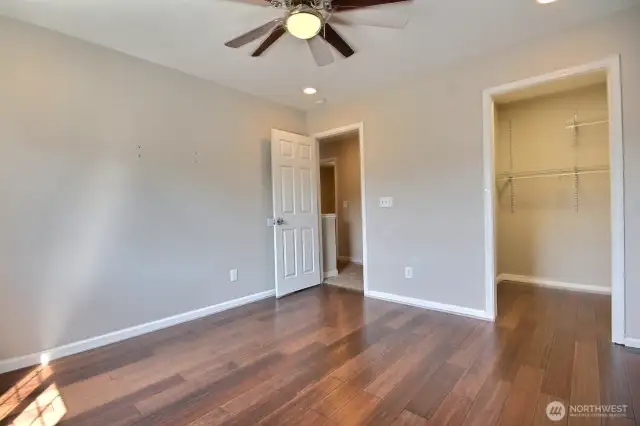 Large guest bedroom #3 features wood laminate flooring and a walk-in closet.
