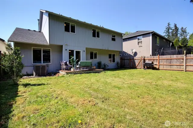 Fully fenced backyard with a deck – ideal for summer BBQs and outdoor fun.