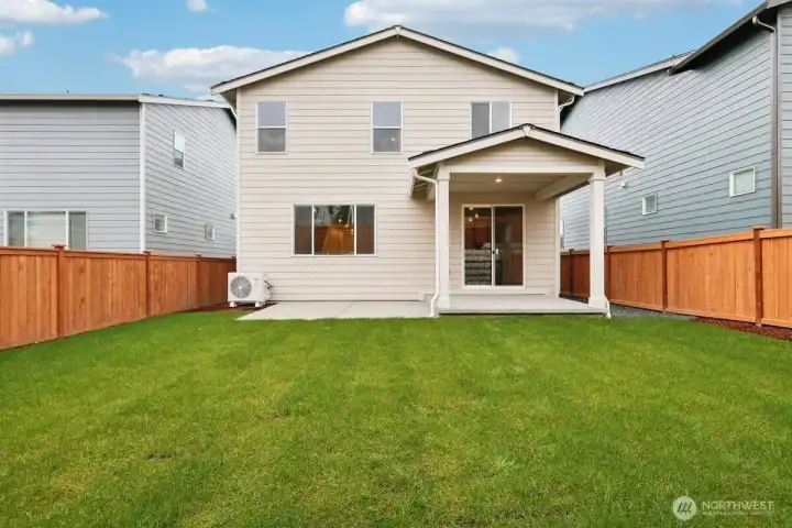 Fully fenced backyard with covered patio and extended slab.