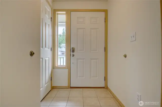 Entry hallway with coat closet (left) and half bath