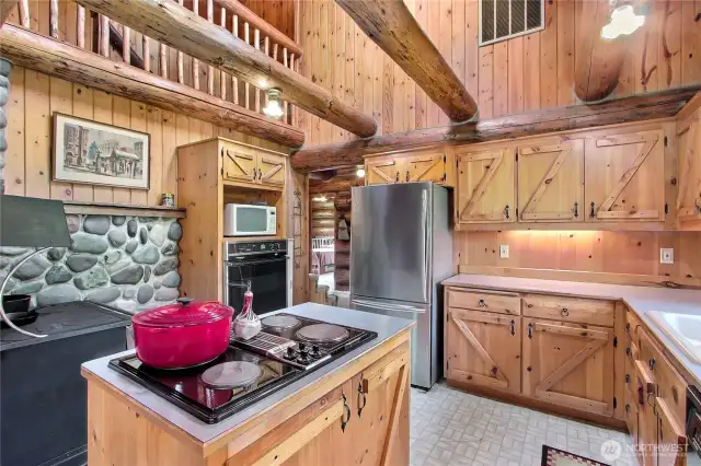 Lots of storage in the kitchen! Notice the upper cat walk to the primary suite.