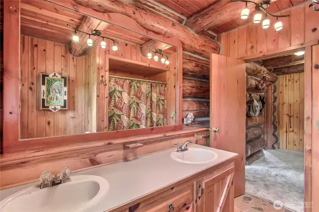 Main floor bathroom with 2 sinks, tub and shower.