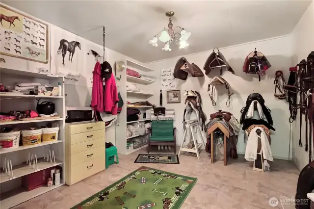 Insulated and heated tack room with lots of storage.