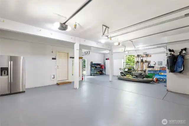 Clean, neat and tidy garage with extra room and door leading to the backyard